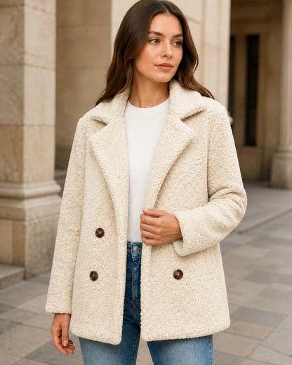 Cream White teddy coat in a neutral stone arcade.